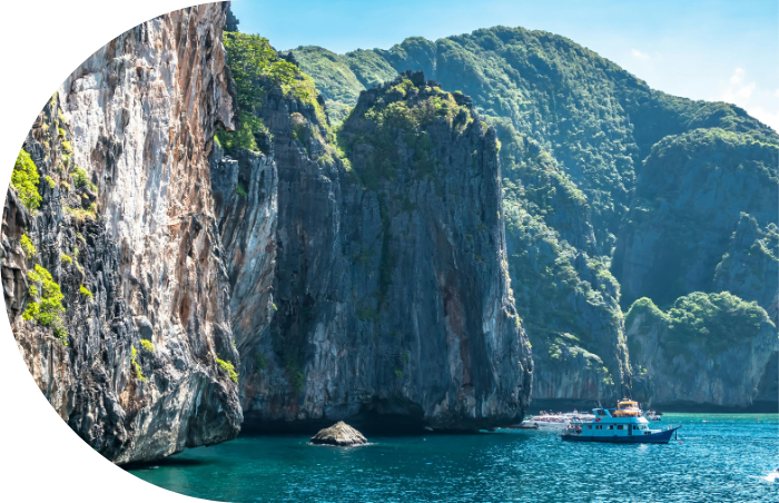 ship in a sea and mountains in the background