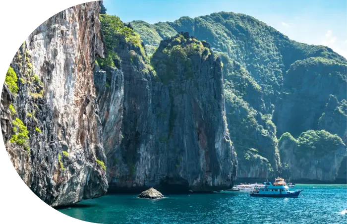 ship in a sea and mountains in the background